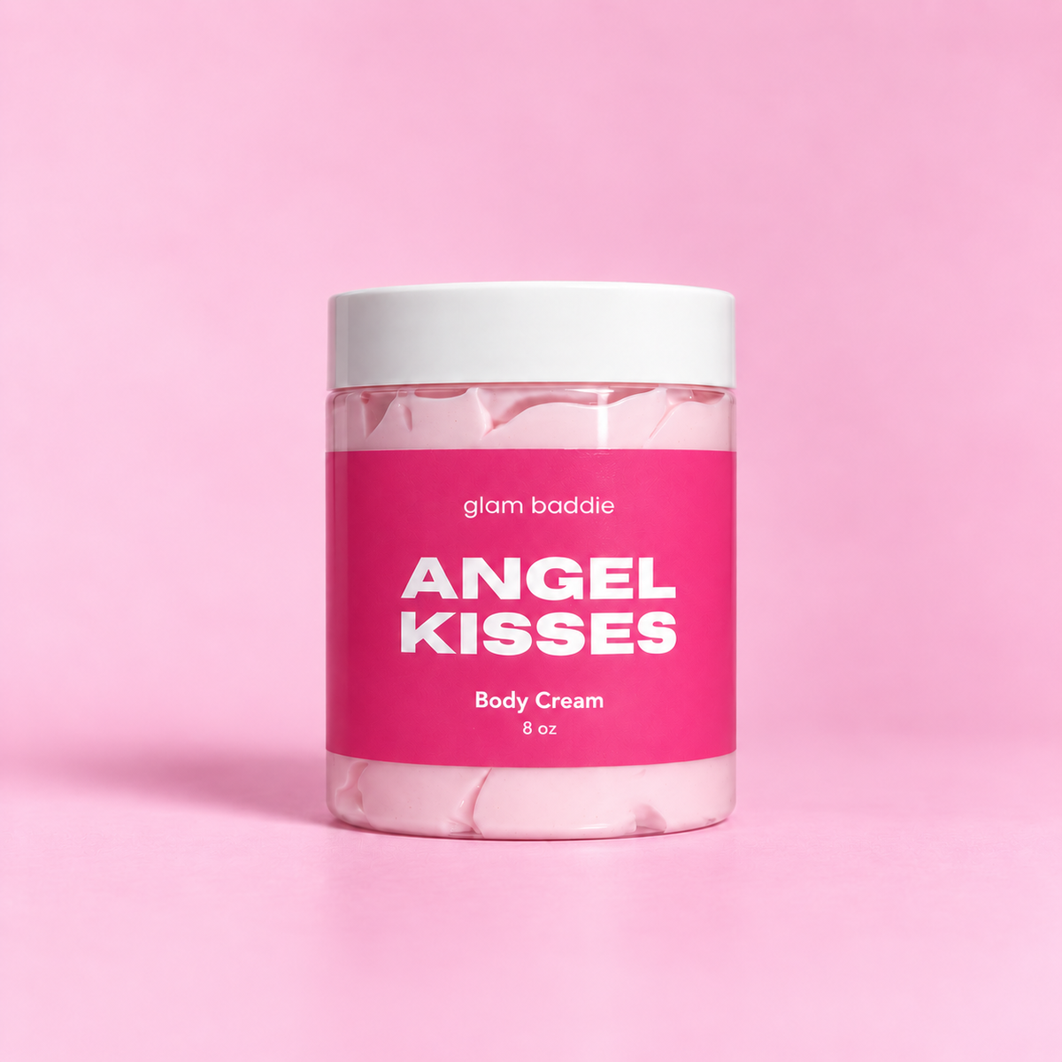 Glam Baddie Angel Kisses Body Cream 8 oz jar with pink label on a pink background.