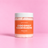 Glam Baddie Coconut Cashmere Body Cream 8 oz jar with orange label on a pink background.