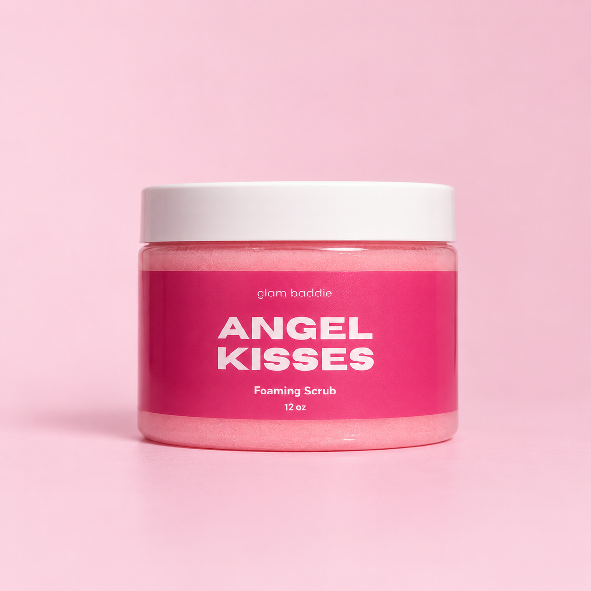 Glam Baddie Angel Kisses Foaming Sugar Scrub, 12 oz jar with pink label on a pink background.
